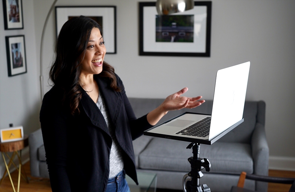 Image of Donna Santos using a tripod with laptop stand to ensure her eyes are level with the camera in her laptop. Photo courtesy of Donna Santos Photography. 