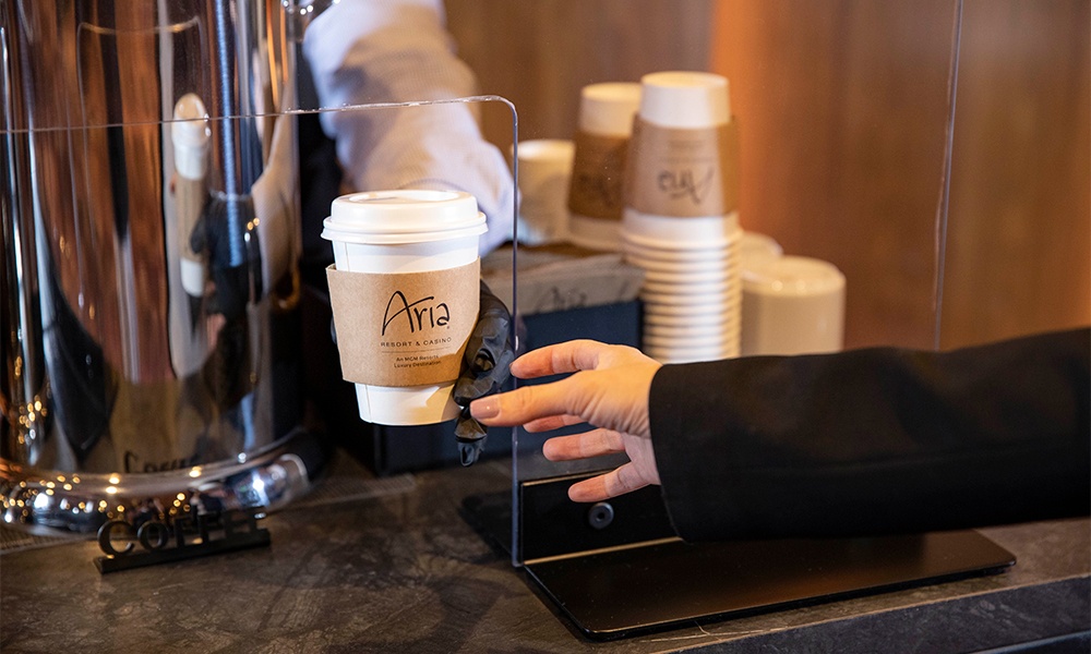 MGM Resorts has launched a new program for safely holding meetings and conventions. Convene with Confidence is available at all MGM properties. Shown here: Coffee service with plexiglas divider separating server from attendee. Photo courtesy of MGM Resorts.