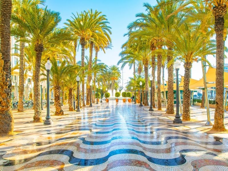 Spain's climate is temperate with more than 3,000 hours of sunshine. Photo here shows a promenade in the seaside town of Alicante. Photo is by arcady_31 | Canva.